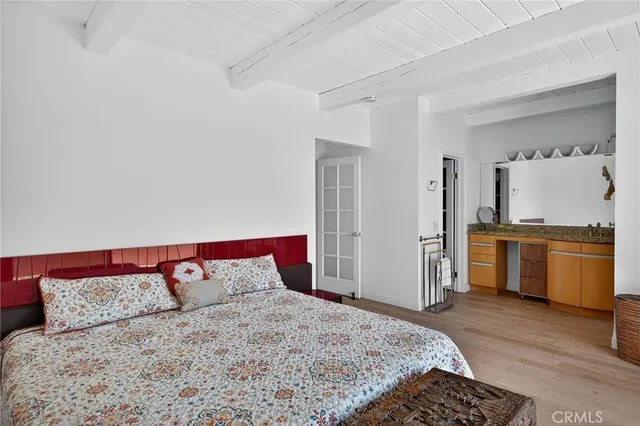 a bedroom with a large bed and a window