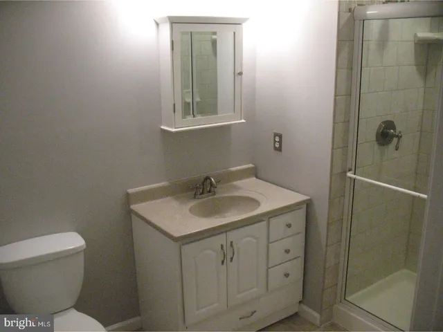a bathroom with a toilet sink and shower