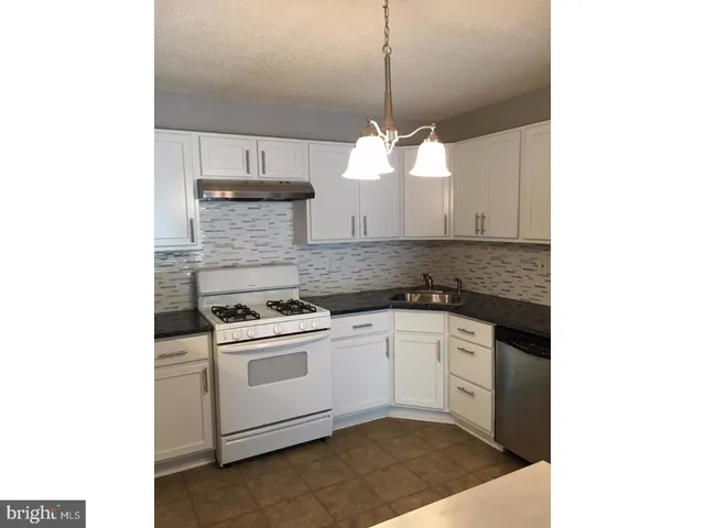 a kitchen with a sink cabinets and window