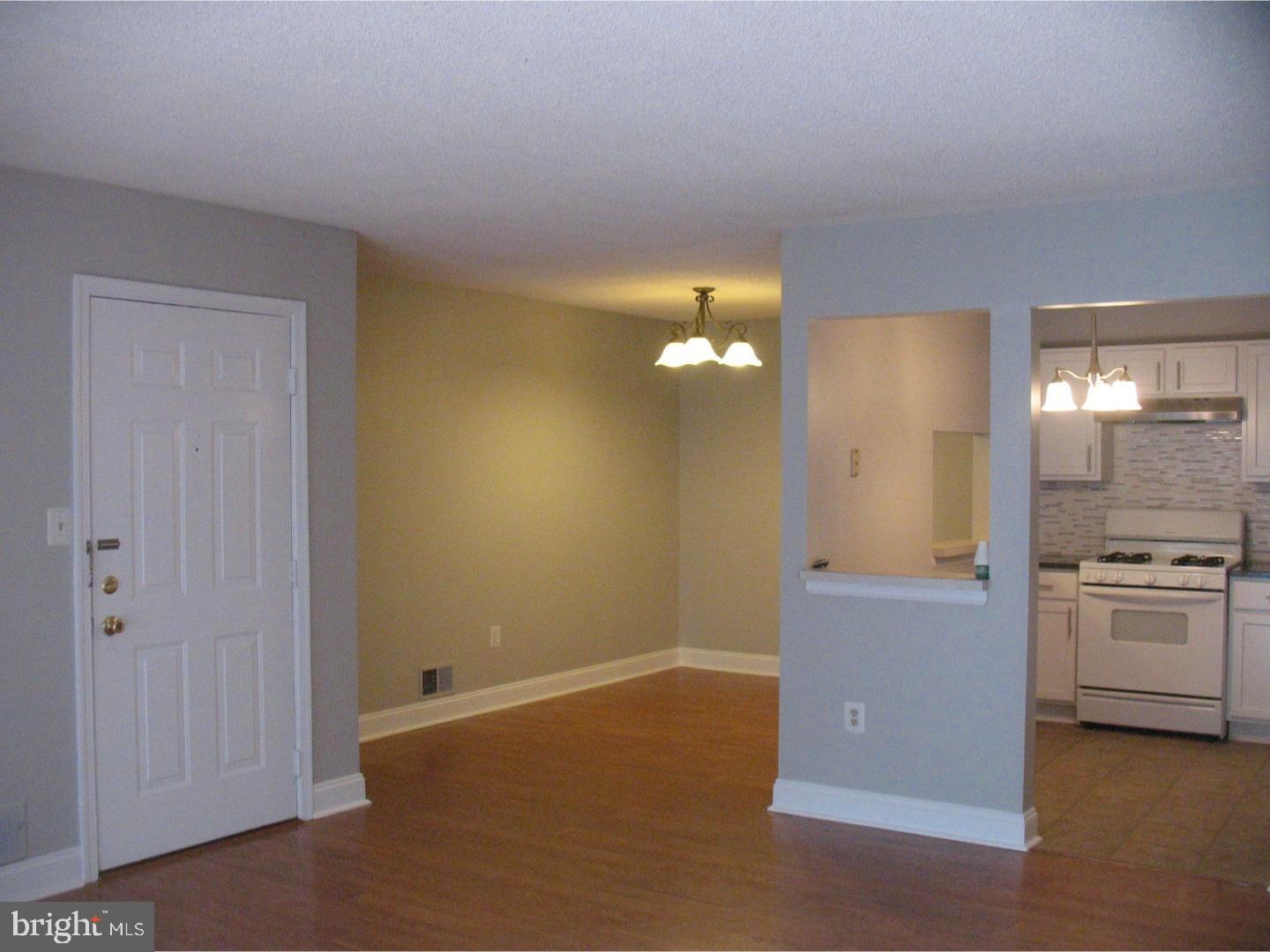 14 Versailles Court Hamilton, NJ 08619 - Photo 6 of 20 a view of a kitchen with a sink and dishwasher kitchen view with wooden floor