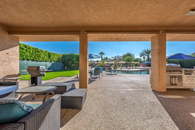 a view of a patio with a table and chairs