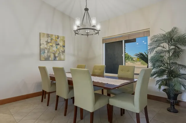a view of a dining room with furniture and chandelier