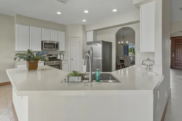 a view of kitchen island a sink and refrigerator