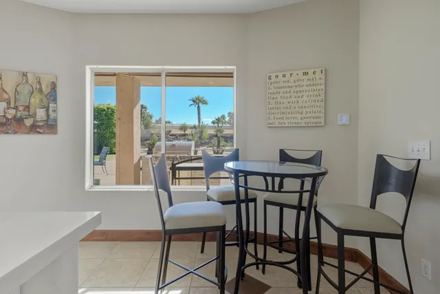 a dining room with furniture and window
