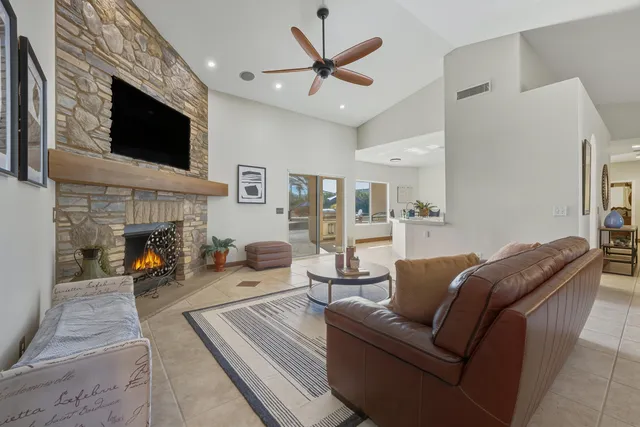 a living room with furniture fireplace and flat screen tv