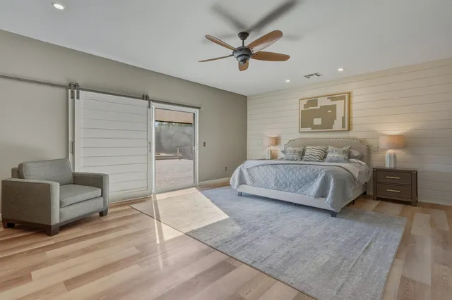 a spacious bedroom with a bed a couch and a window