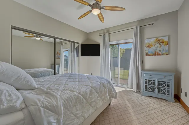 a bedroom with a bed and a television