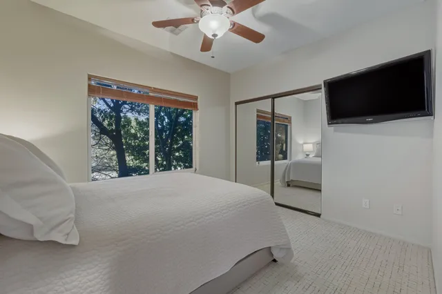 a bedroom with a bed and a flat screen tv