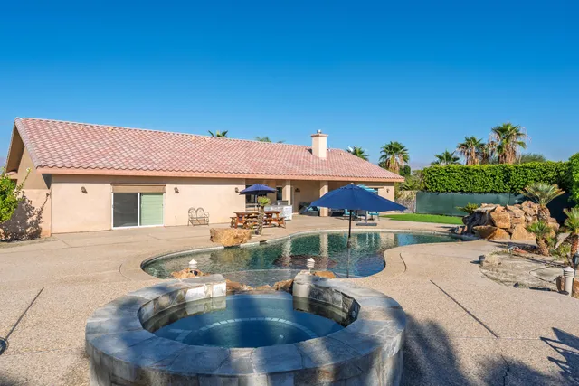 a view of a house with backyard porch and sitting area