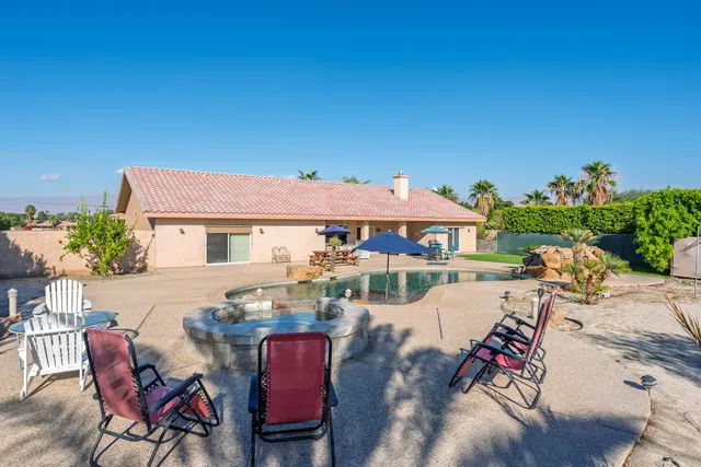 a view of a patio with table and chairs potted plants with wooden floor