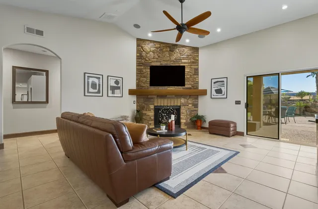 a living room with furniture a flat screen tv and a fireplace