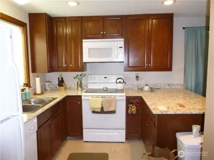 a kitchen with a sink stove and cabinets