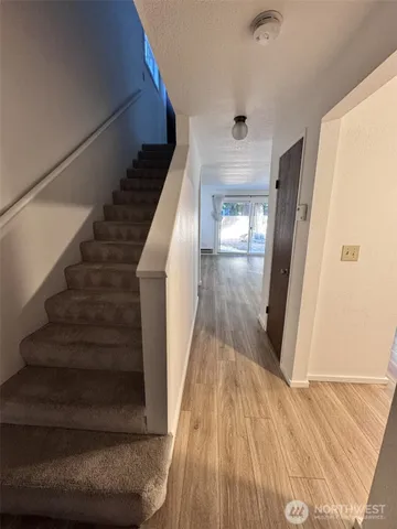a view of entryway and hall with wooden floor