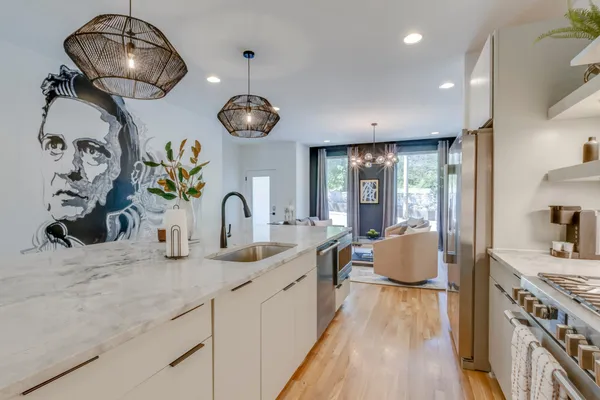 a kitchen with stainless steel appliances granite countertop a stove and a sink with cabinets