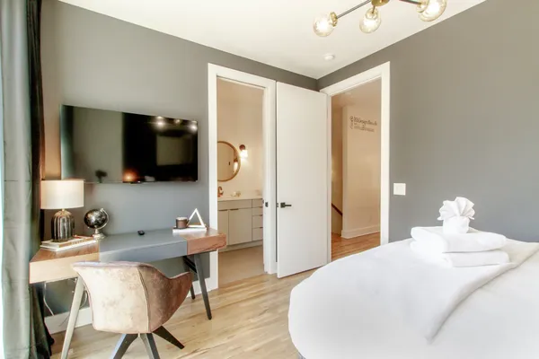 a bedroom with a bed and a flat screen tv