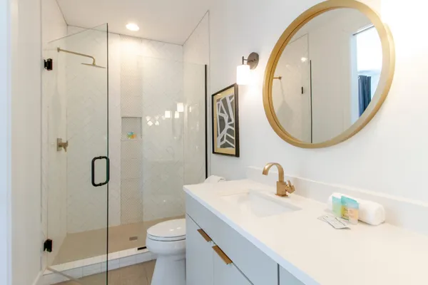 a bathroom with a sink a toilet and a mirror
