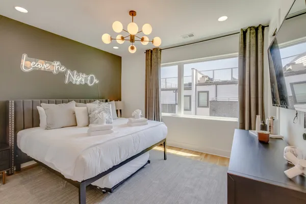 a bedroom with a large bed and a large window
