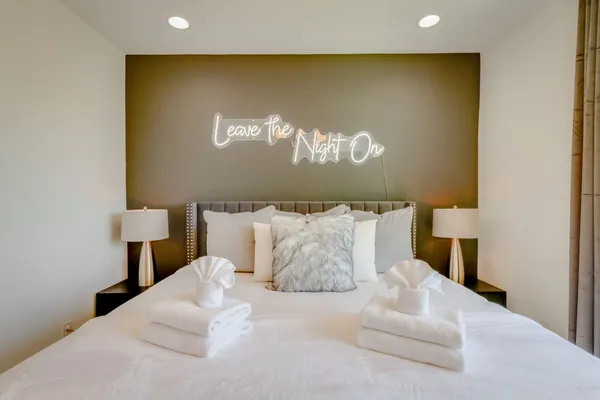 a bed room with a bed and a night stand