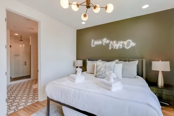 a bed room with a bed mirror and a night stand