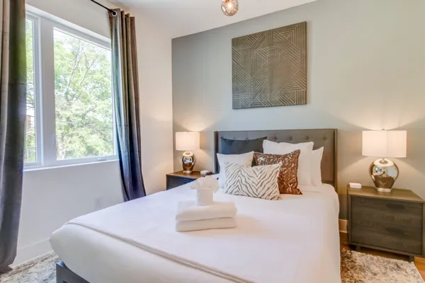 a bedroom with a bed and window