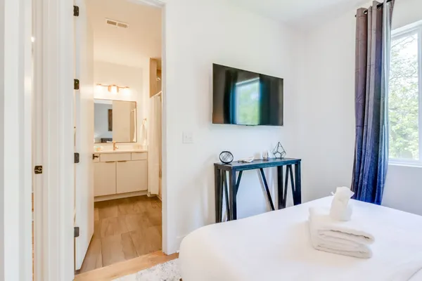 a en suite bathroom with a sink a mirror and a bathtub