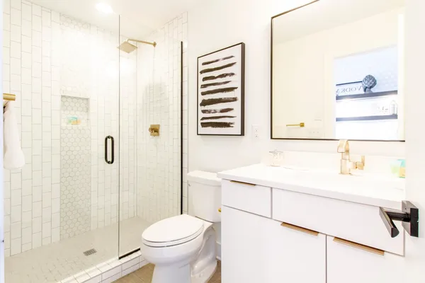 a bathroom with a sink toilet and shower