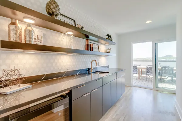 a kitchen with granite countertop a sink and a stove