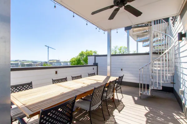 a view of an outside dining space with furniture
