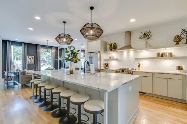 a large kitchen with a table and chairs