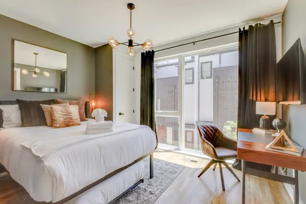 a bedroom with a bed and a desk