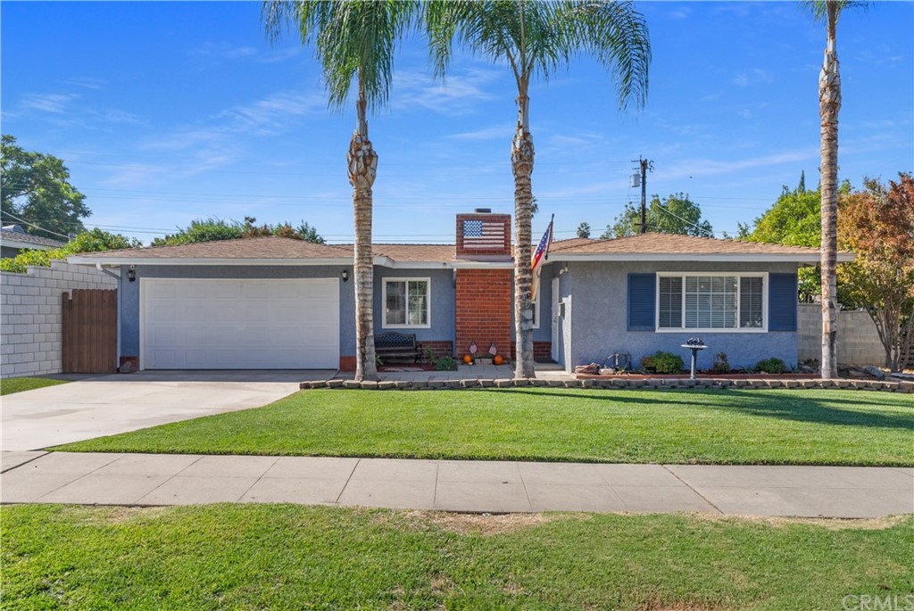 4046 Madrona Road Riverside, CA 92504 - Photo 1 of 1 a front view of a house with a garden and yard