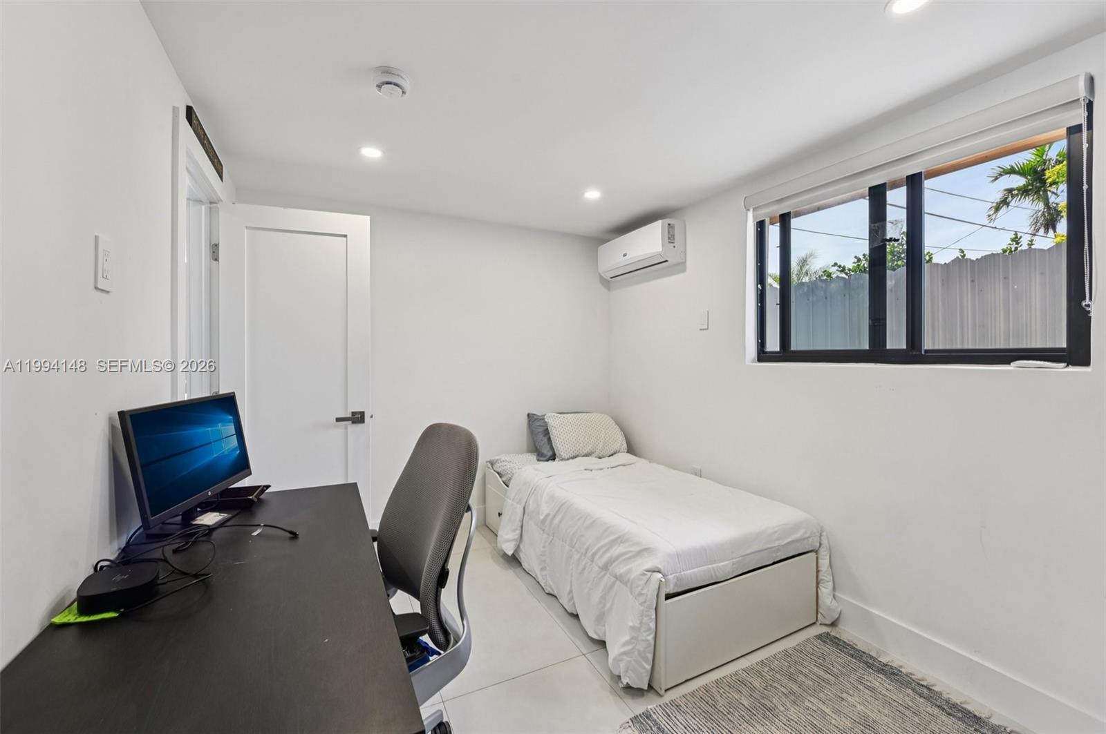 5152 Southwest 6th Street Miami, FL 33134 - Photo 15 of 43 a bedroom with a bed and windows