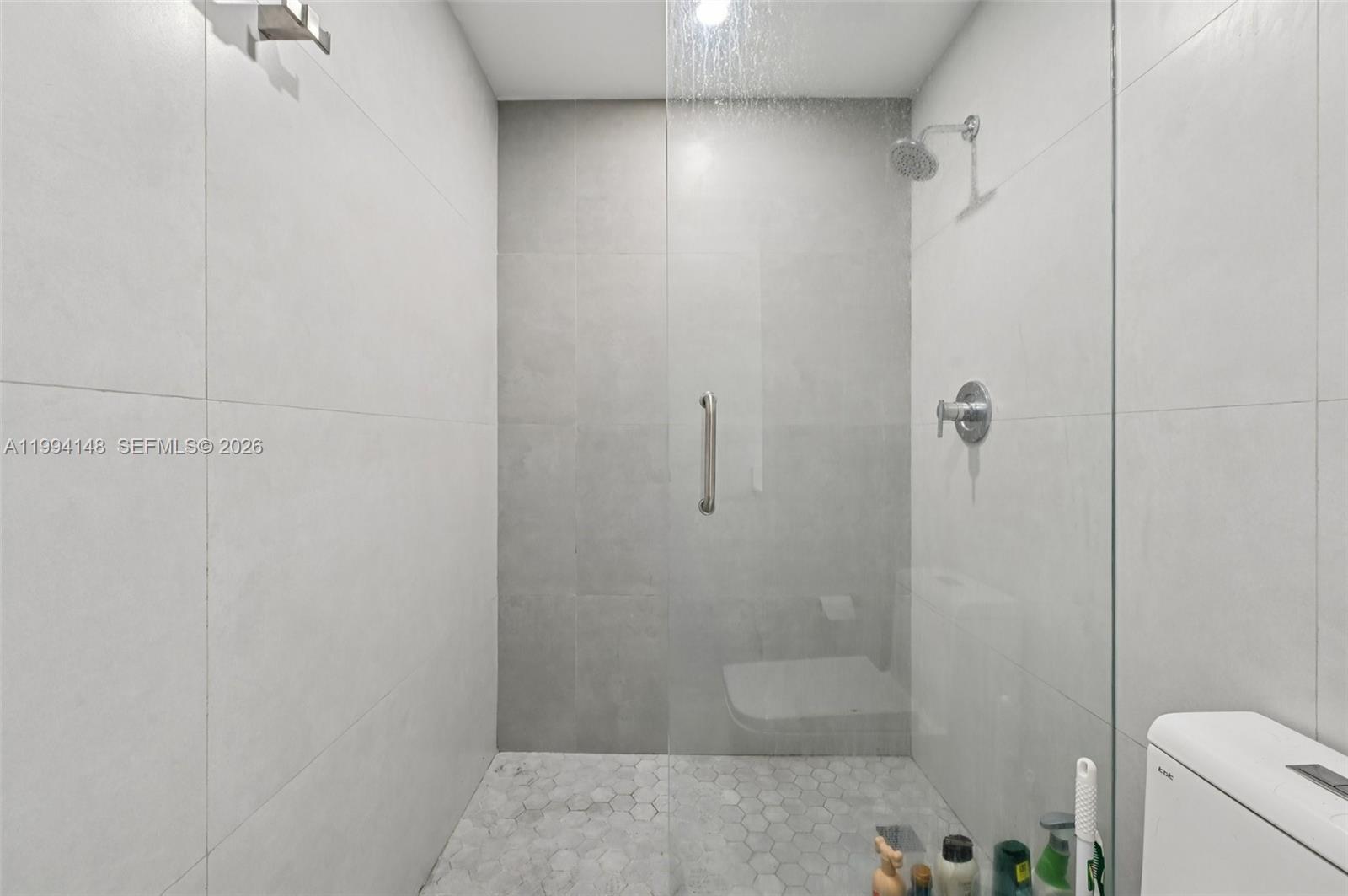 5152 Southwest 6th Street Miami, FL 33134 - Photo 16 of 43 a bathroom with a shower and toilet