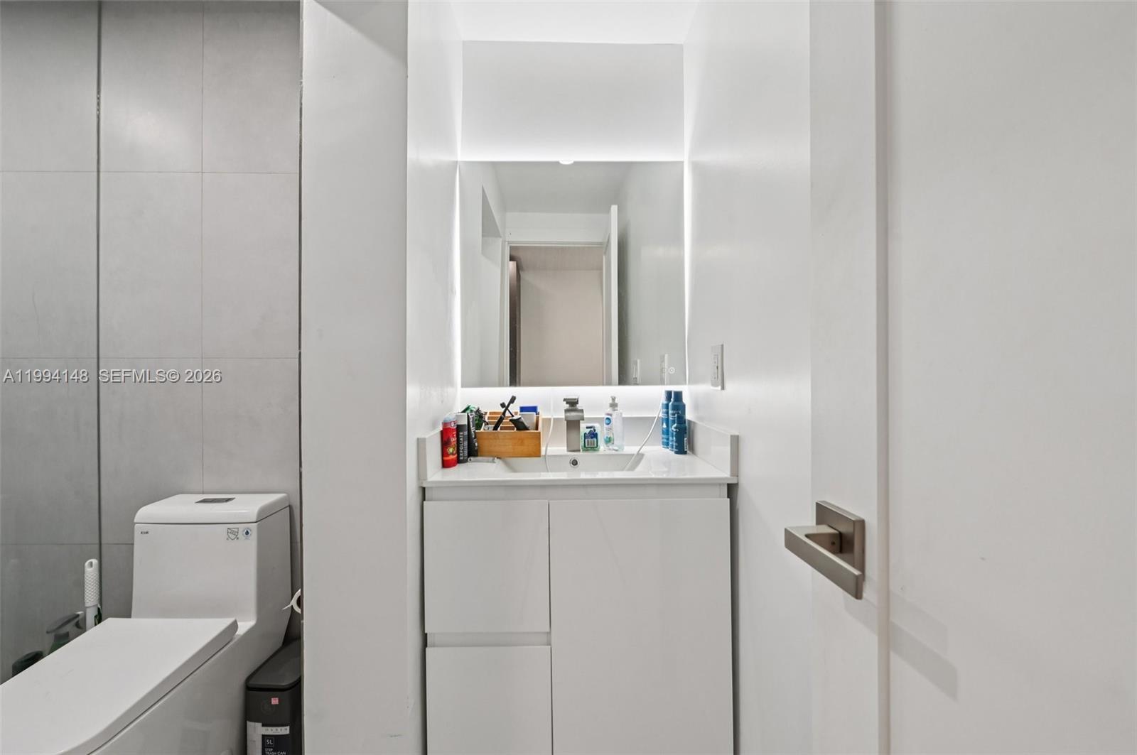 5152 Southwest 6th Street Miami, FL 33134 - Photo 17 of 43 a bathroom with a toilet sink and mirror