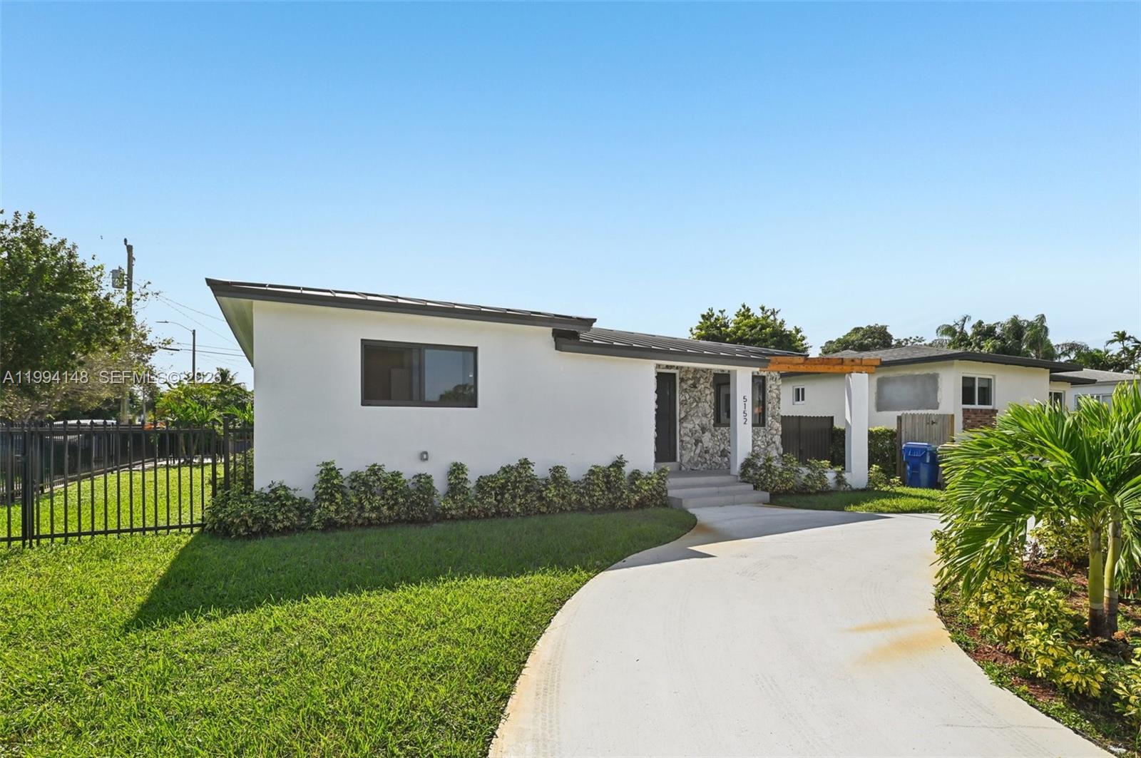 5152 Southwest 6th Street Miami, FL 33134 - Photo 2 of 43 a front view of a house with a garden