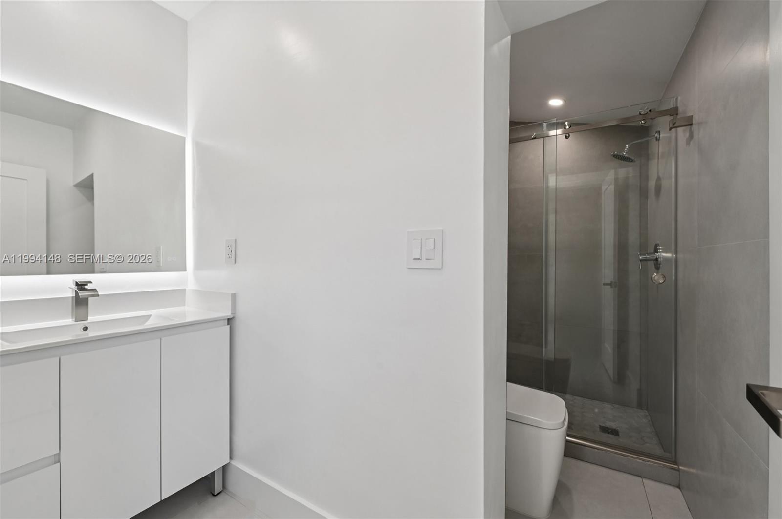 5152 Southwest 6th Street Miami, FL 33134 - Photo 22 of 43 a bathroom with a toilet a sink and shower