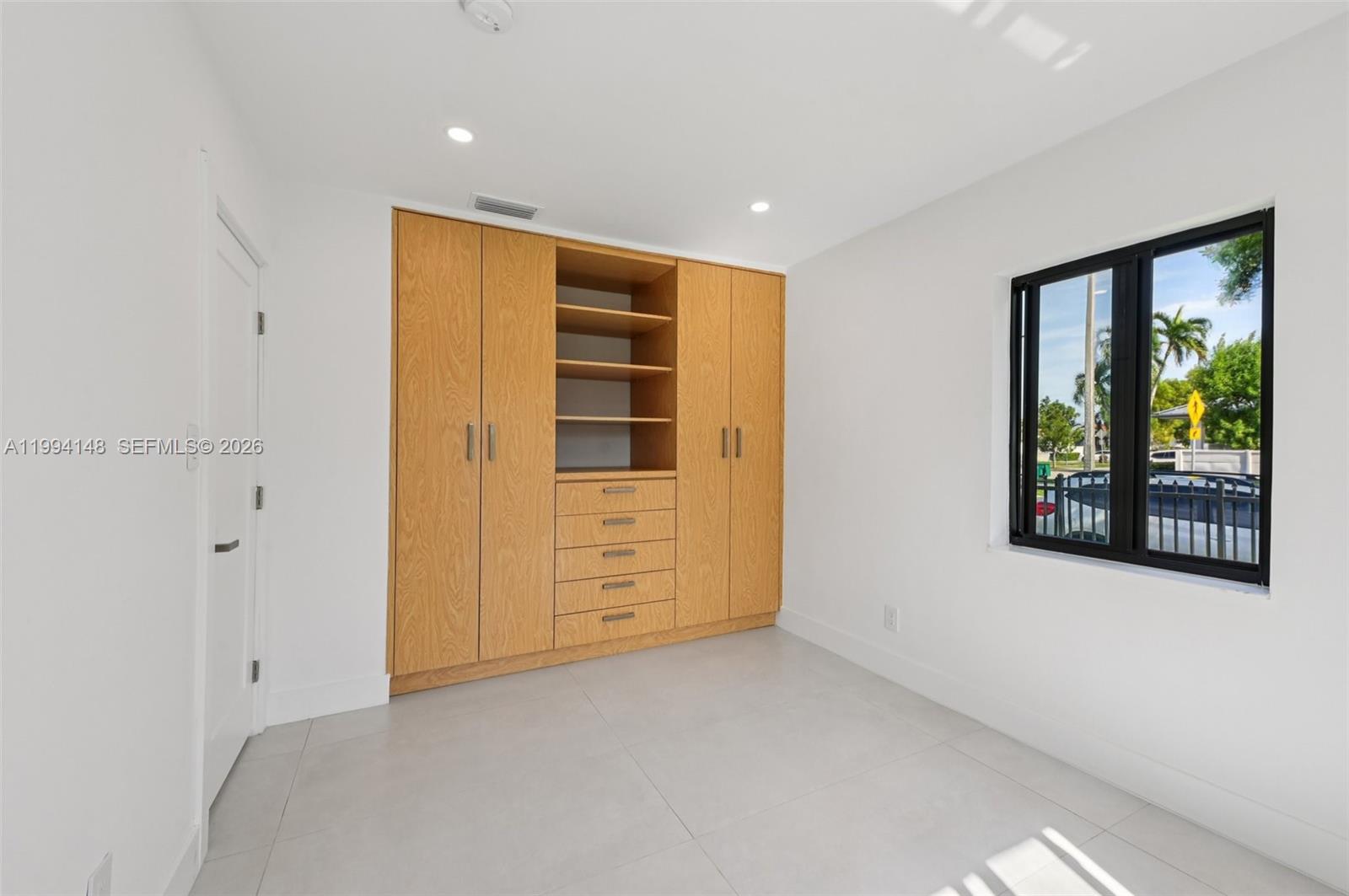 5152 Southwest 6th Street Miami, FL 33134 - Photo 29 of 43 a view of an empty room with window and cabinet