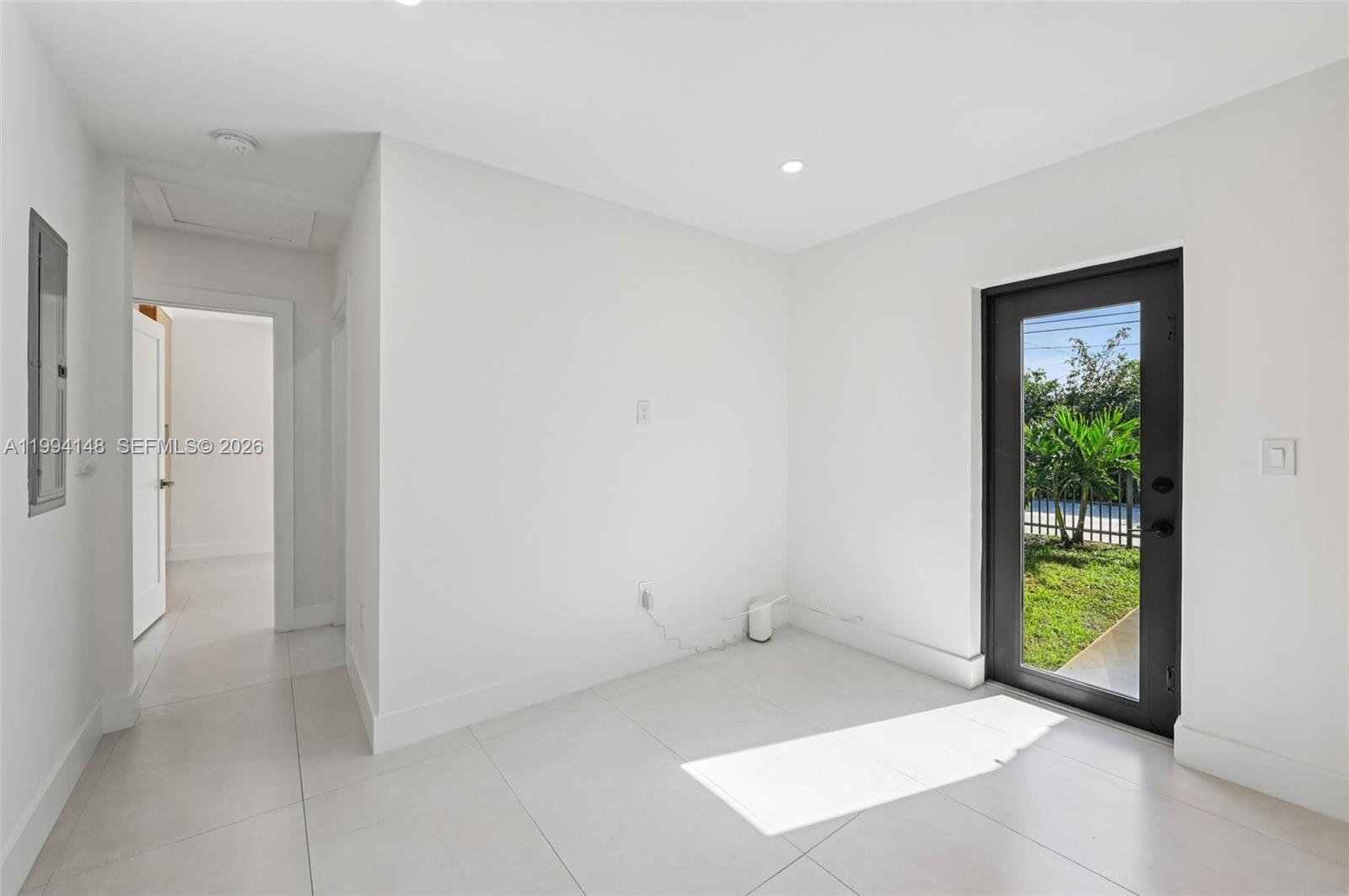 5152 Southwest 6th Street Miami, FL 33134 - Photo 39 of 43 an empty room with floor to ceiling windows and garden