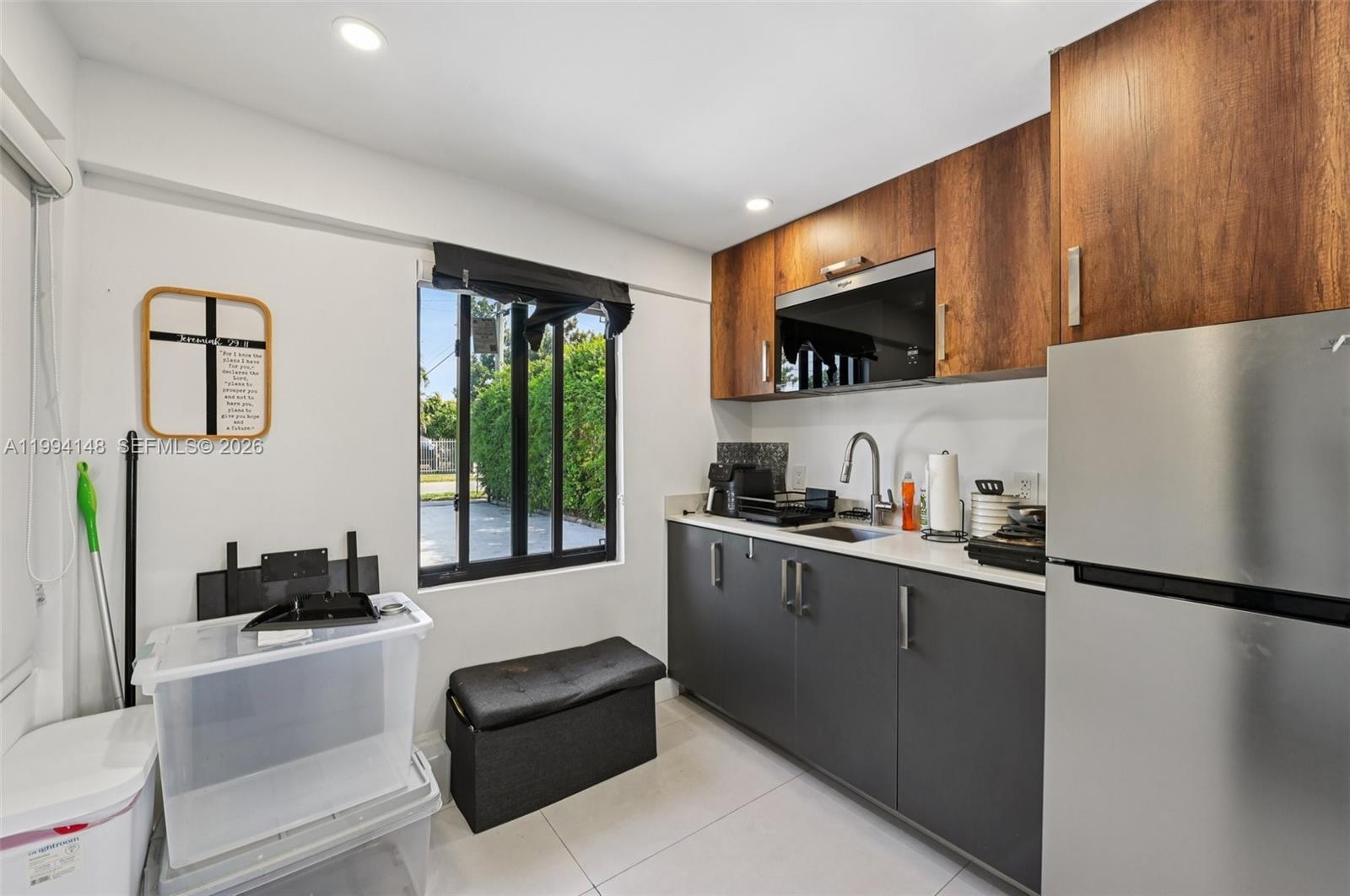 5152 Southwest 6th Street Miami, FL 33134 - Photo 6 of 43 a kitchen with stainless steel appliances a sink stove and refrigerator