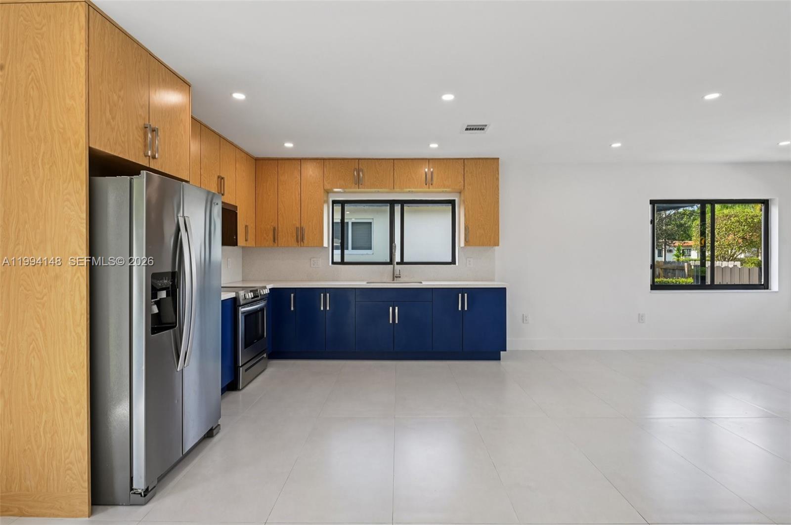 5152 Southwest 6th Street Miami, FL 33134 - Photo 8 of 43 a kitchen with stainless steel appliances granite countertop a refrigerator a sink and a large window