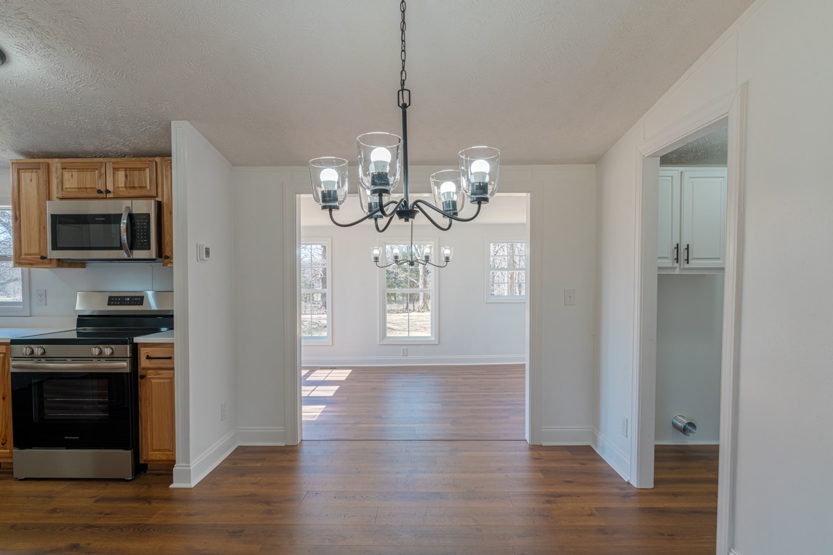 4214 Oregon Road Springfield, TN 37172 - Photo 12 of 37 a view of a kitchen with granite countertop wooden floor and stainless steel appliances