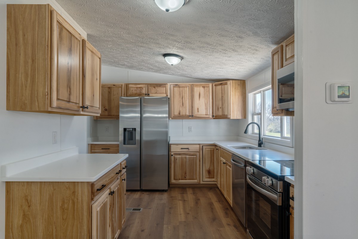 4214 Oregon Road Springfield, TN 37172 - Photo 16 of 37 a kitchen with stainless steel appliances granite countertop a sink stove and refrigerator