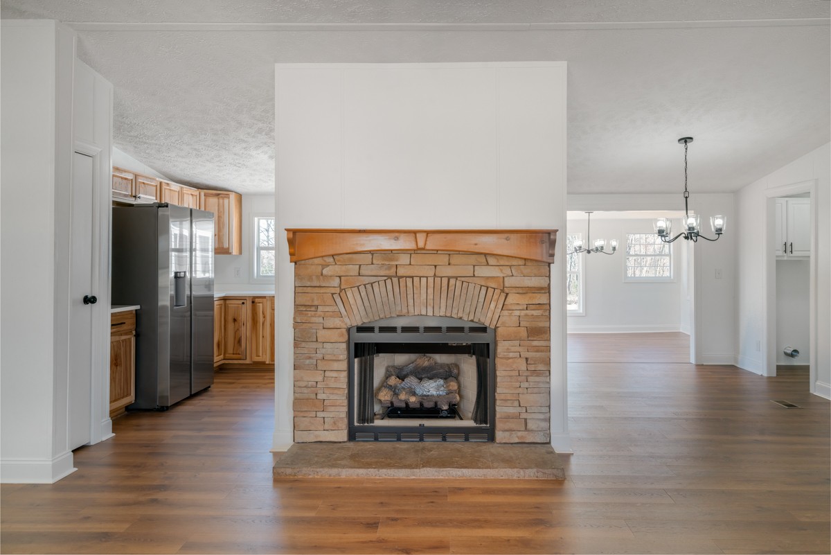 4214 Oregon Road Springfield, TN 37172 - Photo 8 of 37 a living room with a fireplace and a wooden floor