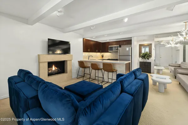 a living room with furniture fireplace and flat screen tv