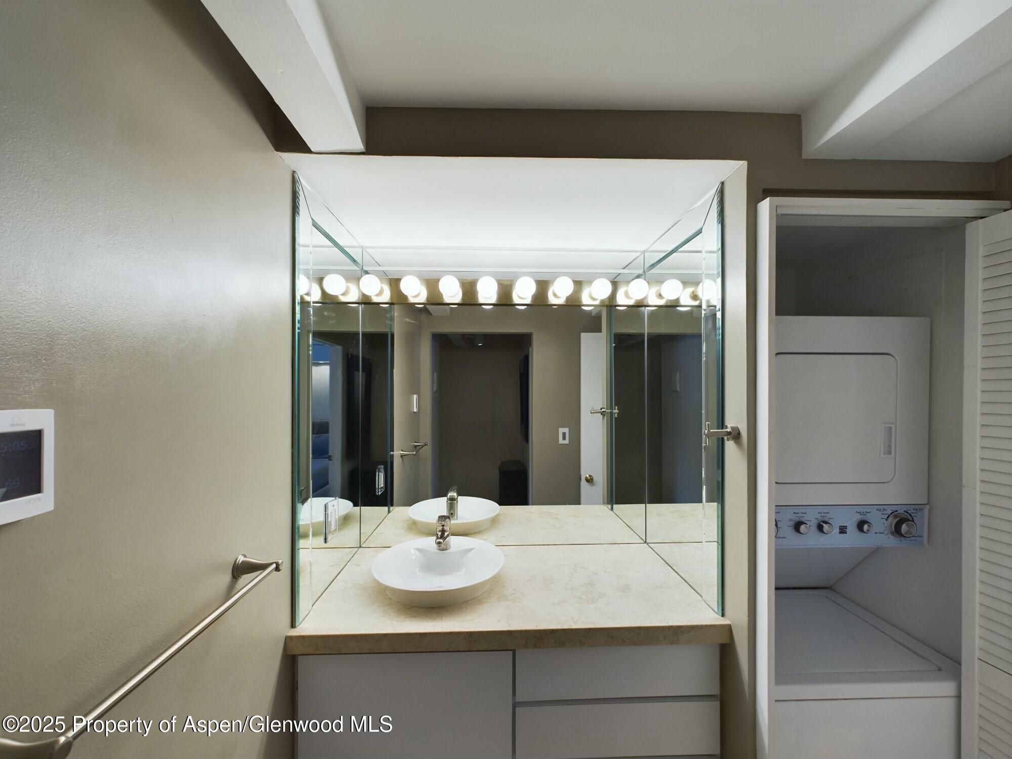 601 South W End Street, Unit 7 Aspen, CO 81611 - Photo 11 of 13 a bathroom with a sink and a mirror