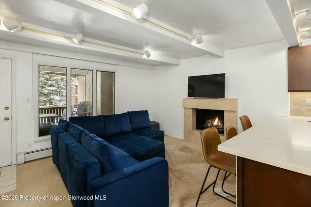 a living room with furniture a fireplace and a flat screen tv