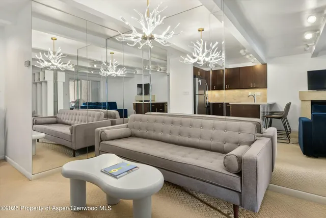 a living room with furniture a chandelier and a chandelier