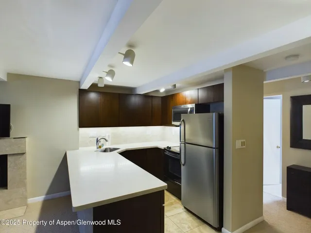 a kitchen with stainless steel appliances a refrigerator and a sink