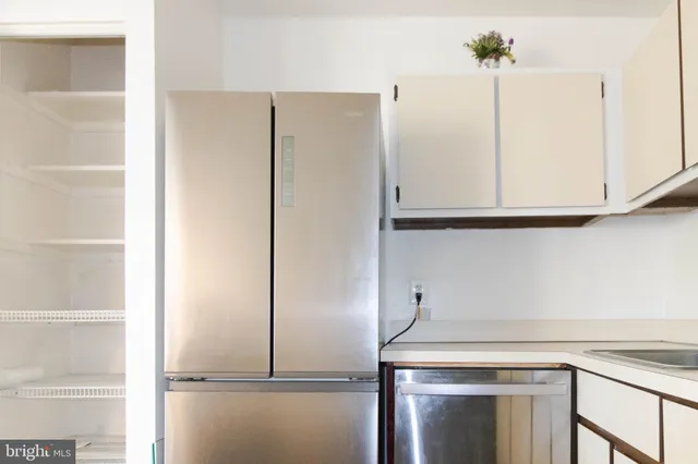 a kitchen with a sink stainless steel appliances and cabinets