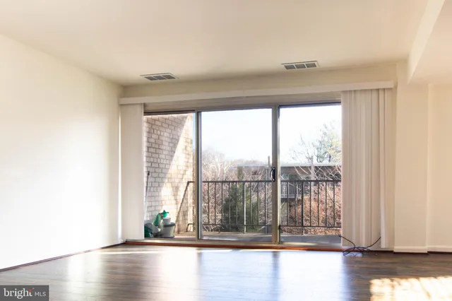 a view of a room with wooden floor
